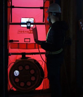 An Energy Advisor Performing a Blower Door Test